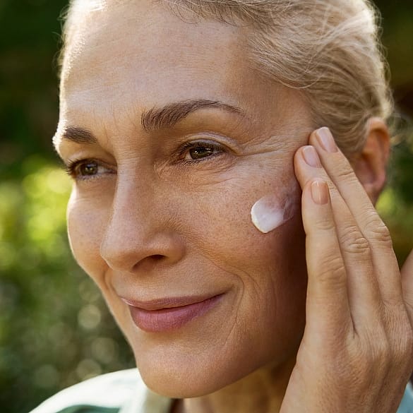 woman applying creme